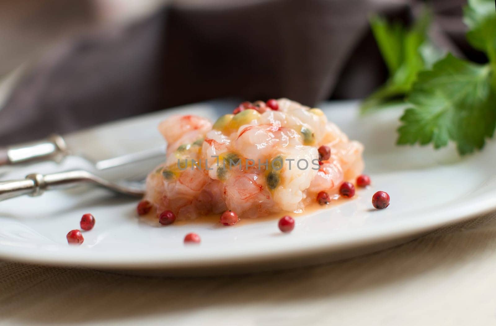 Delicious raw shrimps tartare with passion fruit and red pepper
