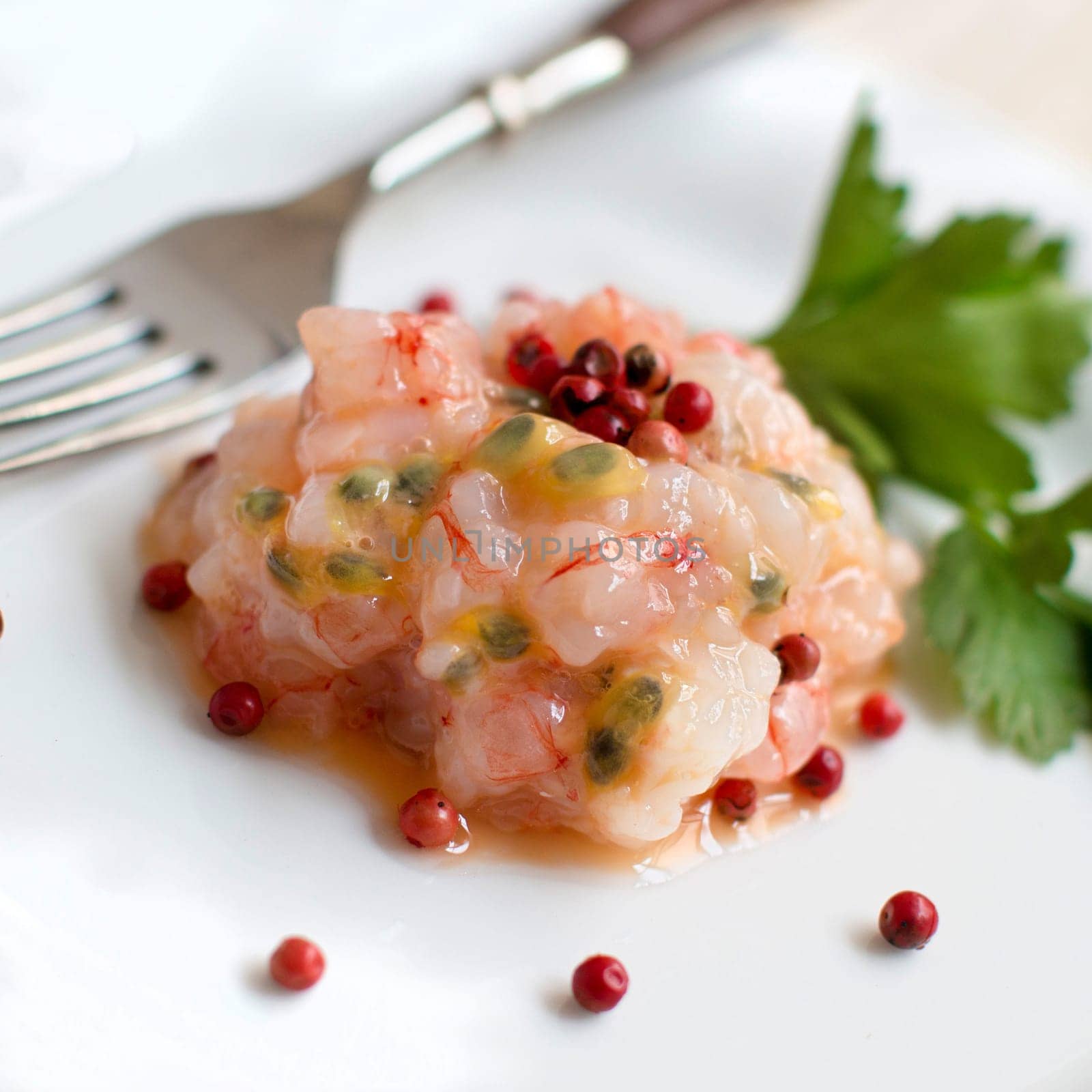 Delicious raw shrimps tartare with passion fruit and red pepper