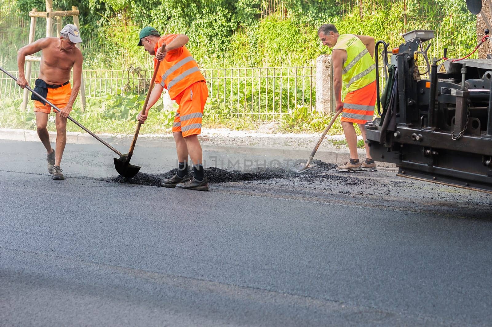 Udine ,Italy - June 28 2016 : Workers on a road construction, industry and teamwork