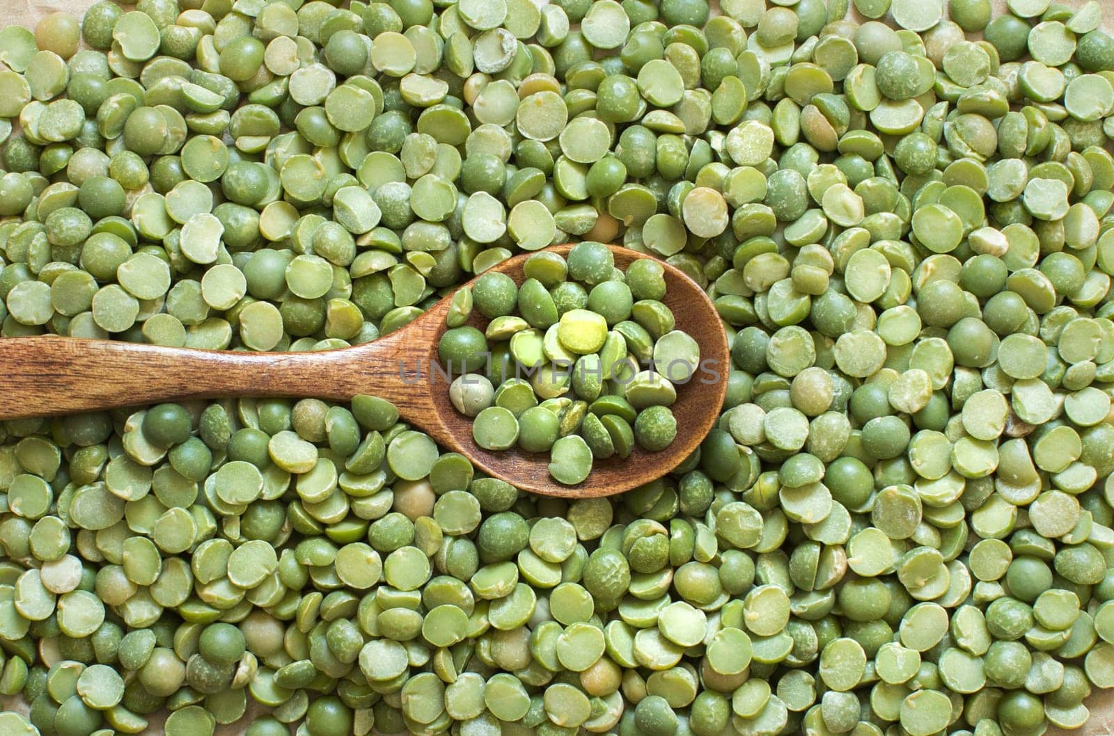 Dried Green Split Peas with a spoon close up