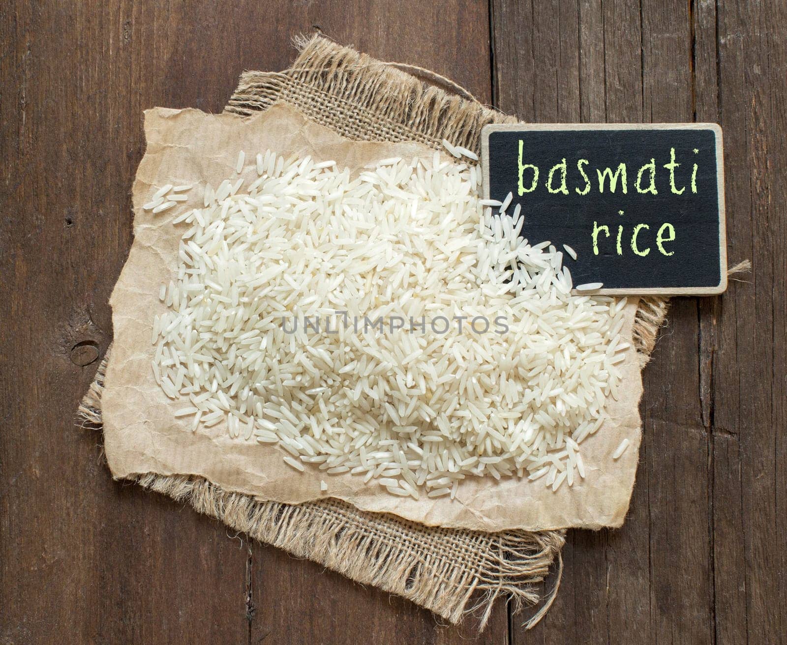 Basmati raw rice on wood with a small chalkboard
