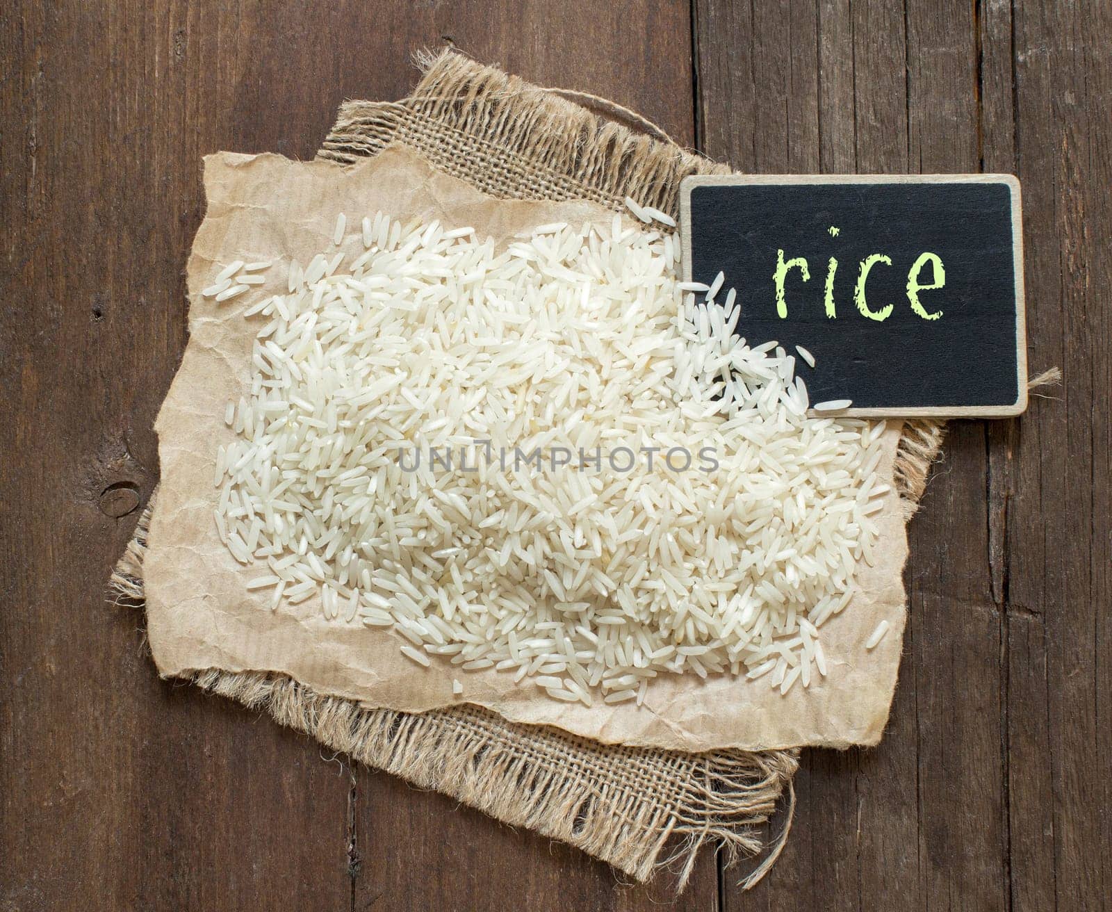 Basmati raw rice on wood with a small chalkboard