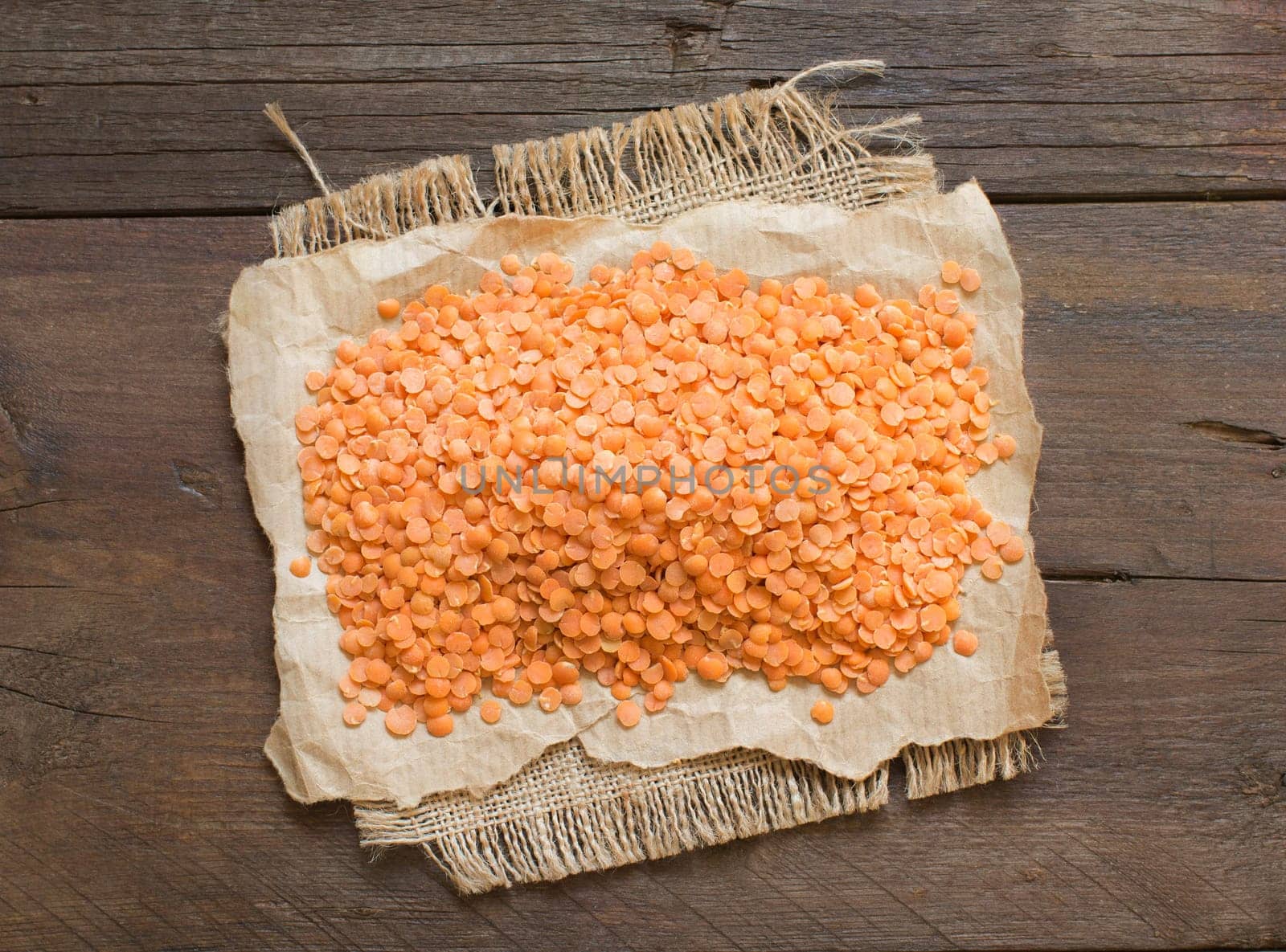 Red lentils on a dark table top view