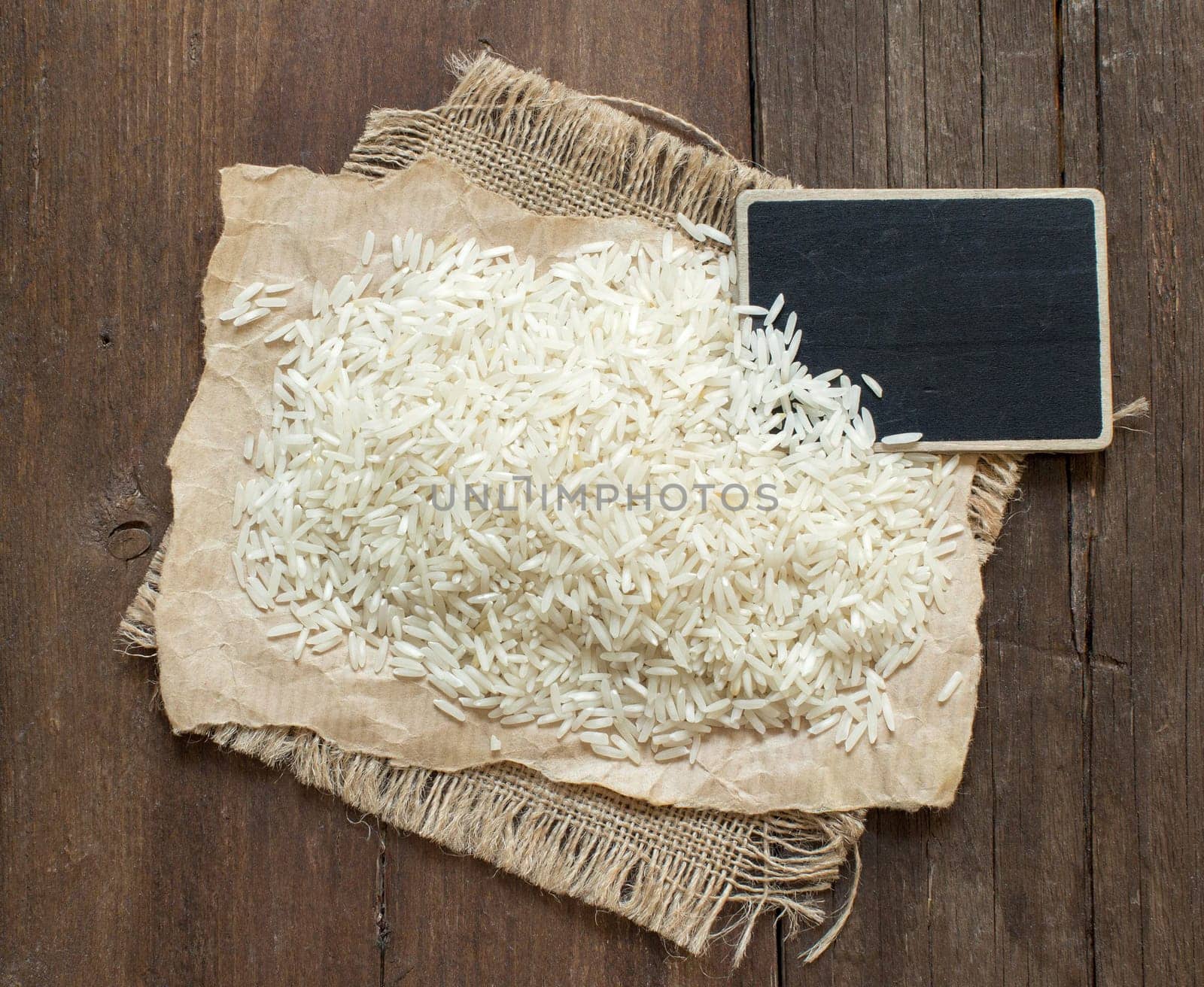 Basmati raw rice on wood with a small chalkboard