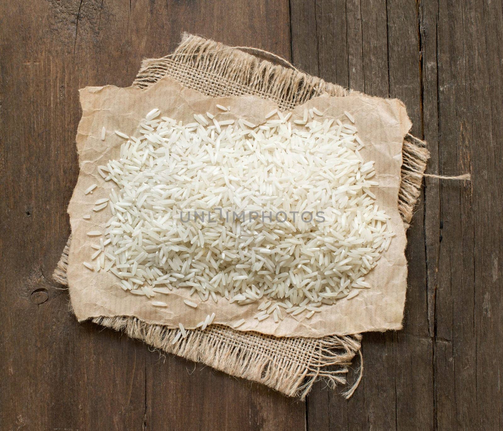 Basmati raw rice on old wooden table top view