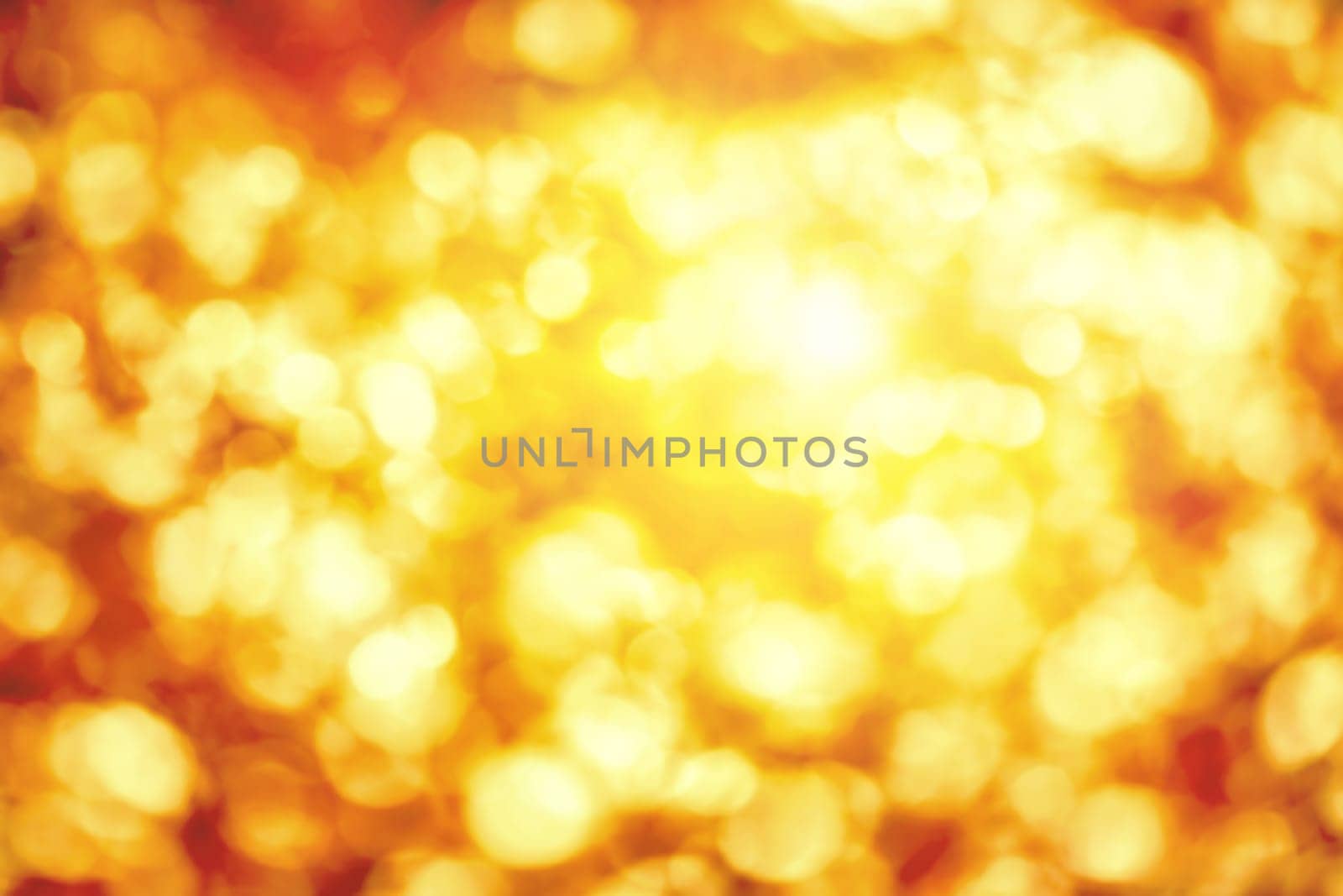 Shining out-of-focus highlights in gold and yellow,a bright bokeh background ideal for autumn or Christmas
