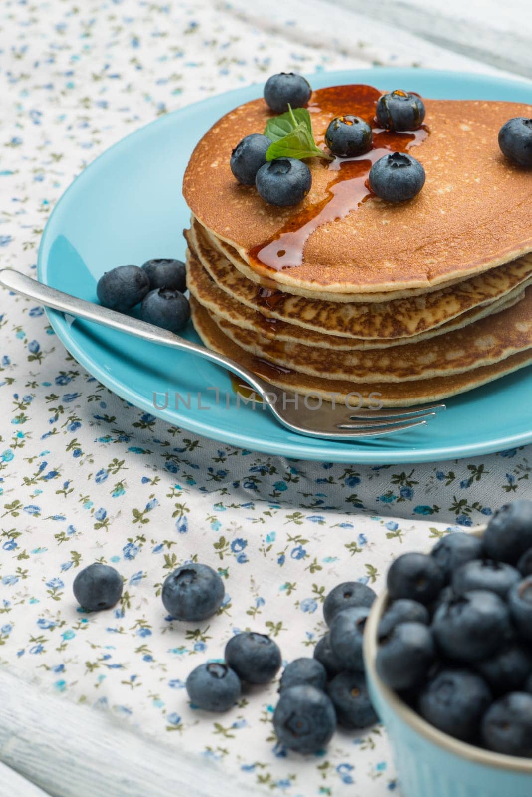 Delicious golden pancakes with fresh blackberries.