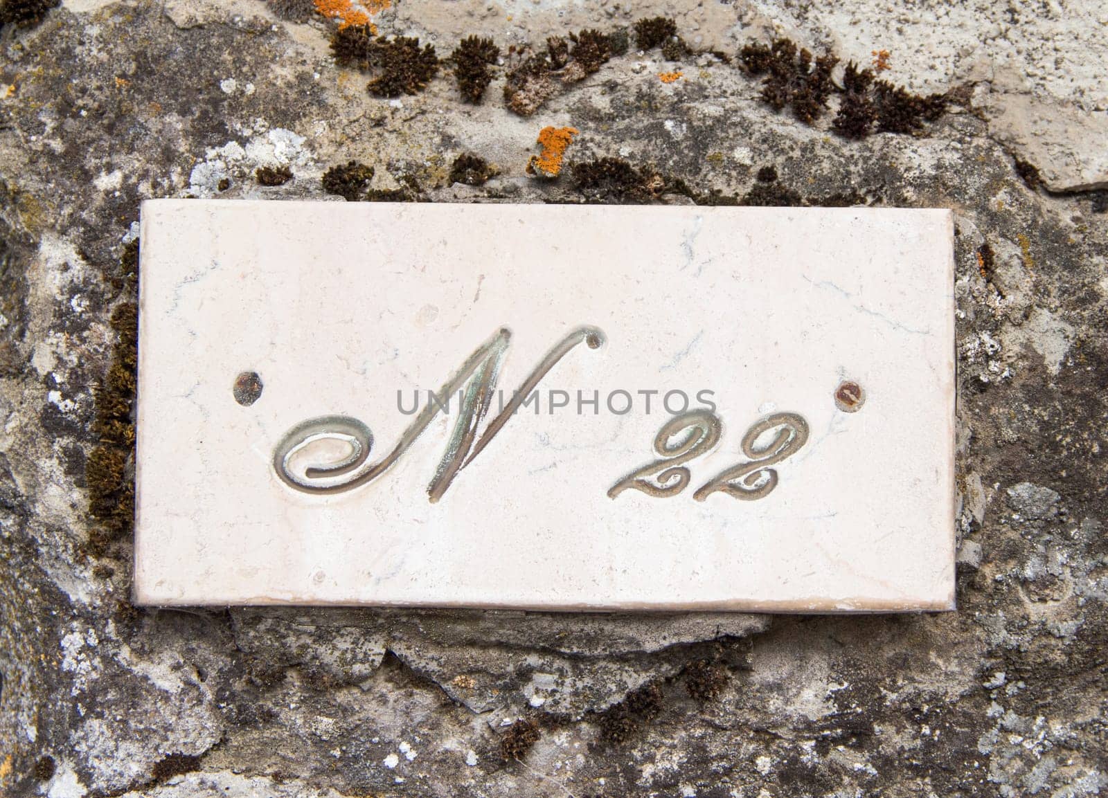 Number twenty two on the grey stone wall