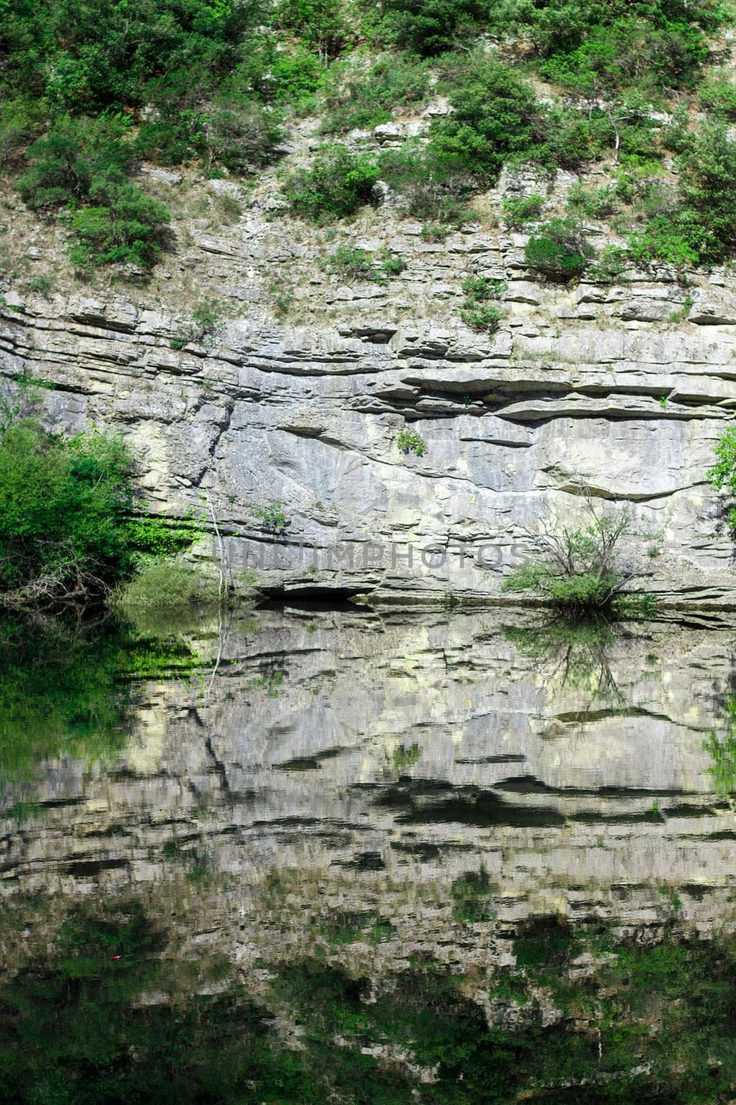 Reflex of climb in mountain lake near Gran Sasso