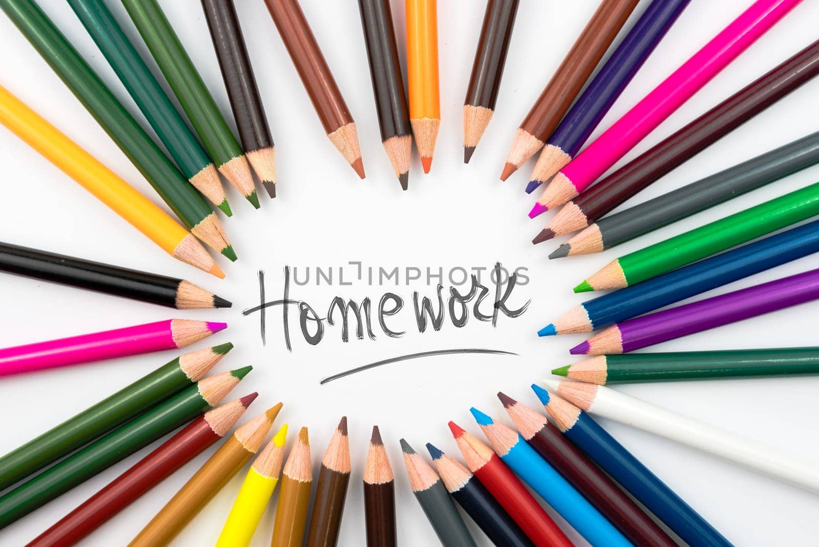 Colouring pencils in circle arrangement with message Homework, education concept