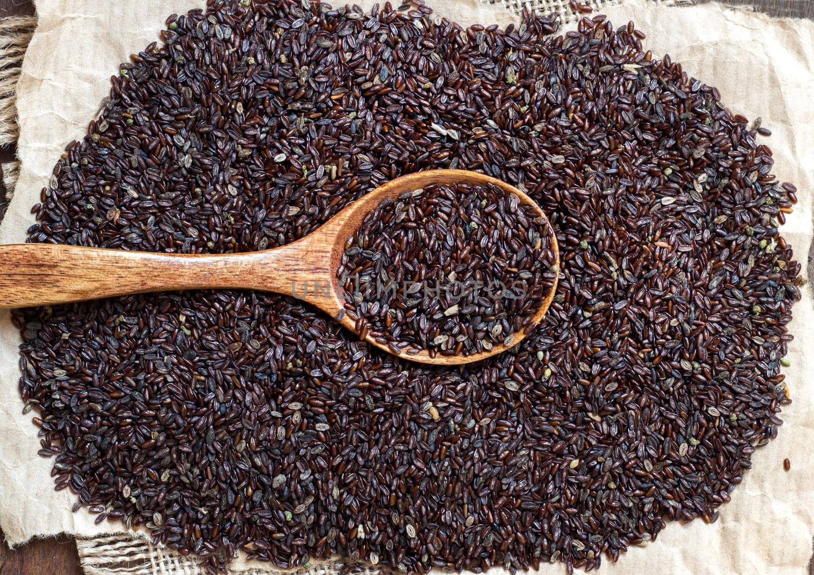 Psyllium seeds with a spoon on a craft paper