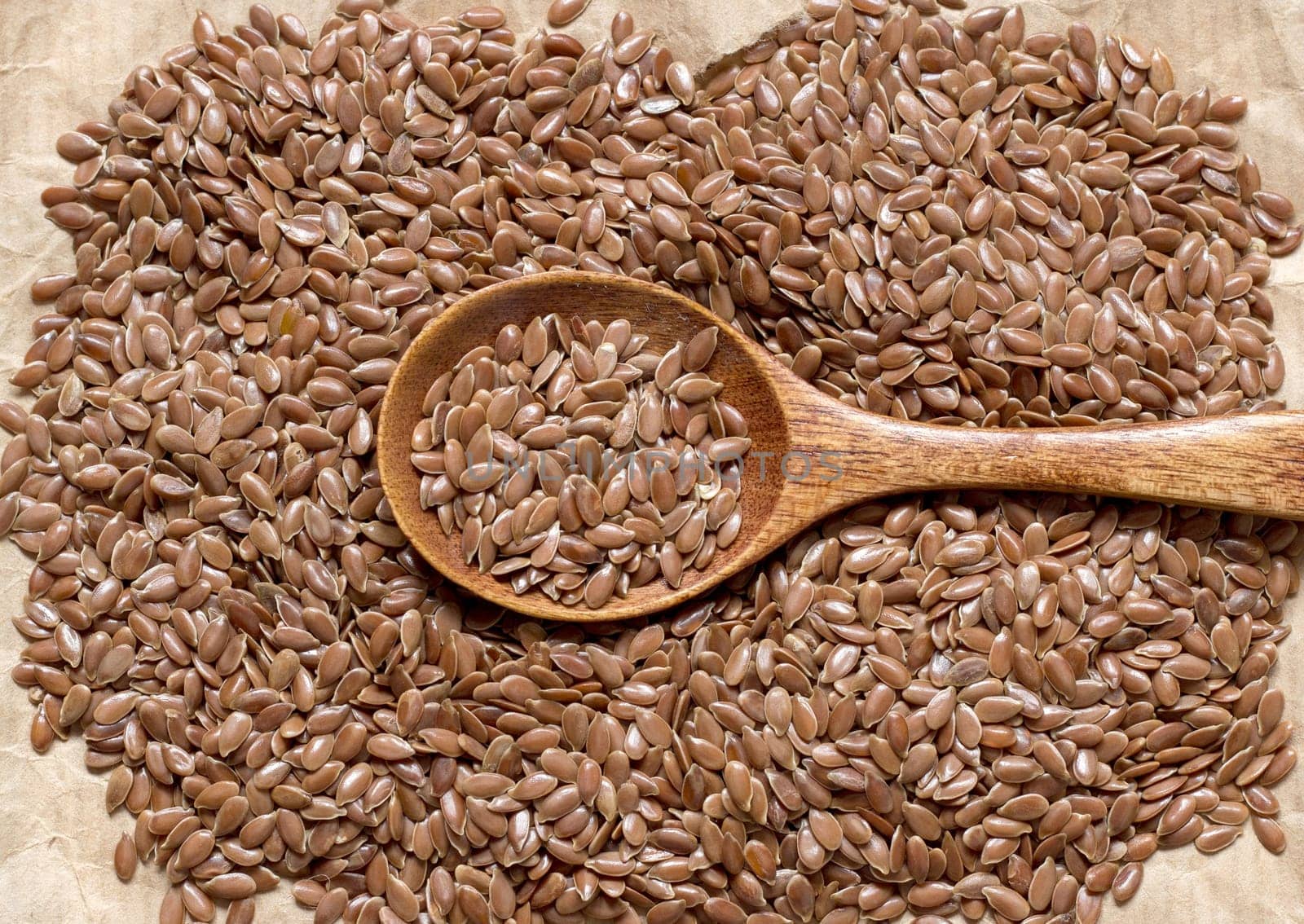 Pile of flax seeds on acraft paper background