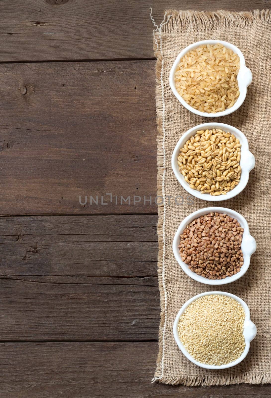 Cereals in bowls border on wooden background