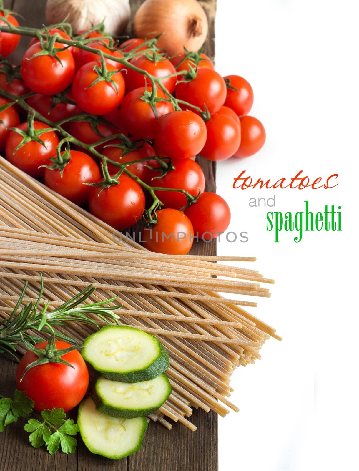 Spaghett, herbs, zucchinii and tomatoes on the old wooden tale