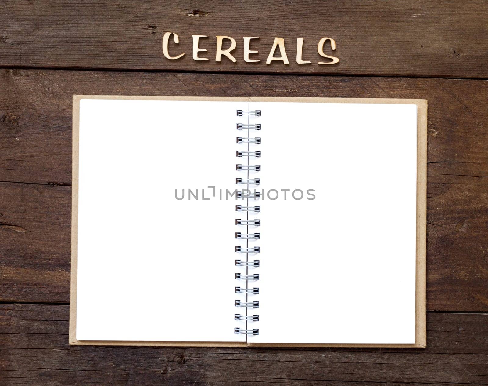 The word of Cereals with notebook on wood