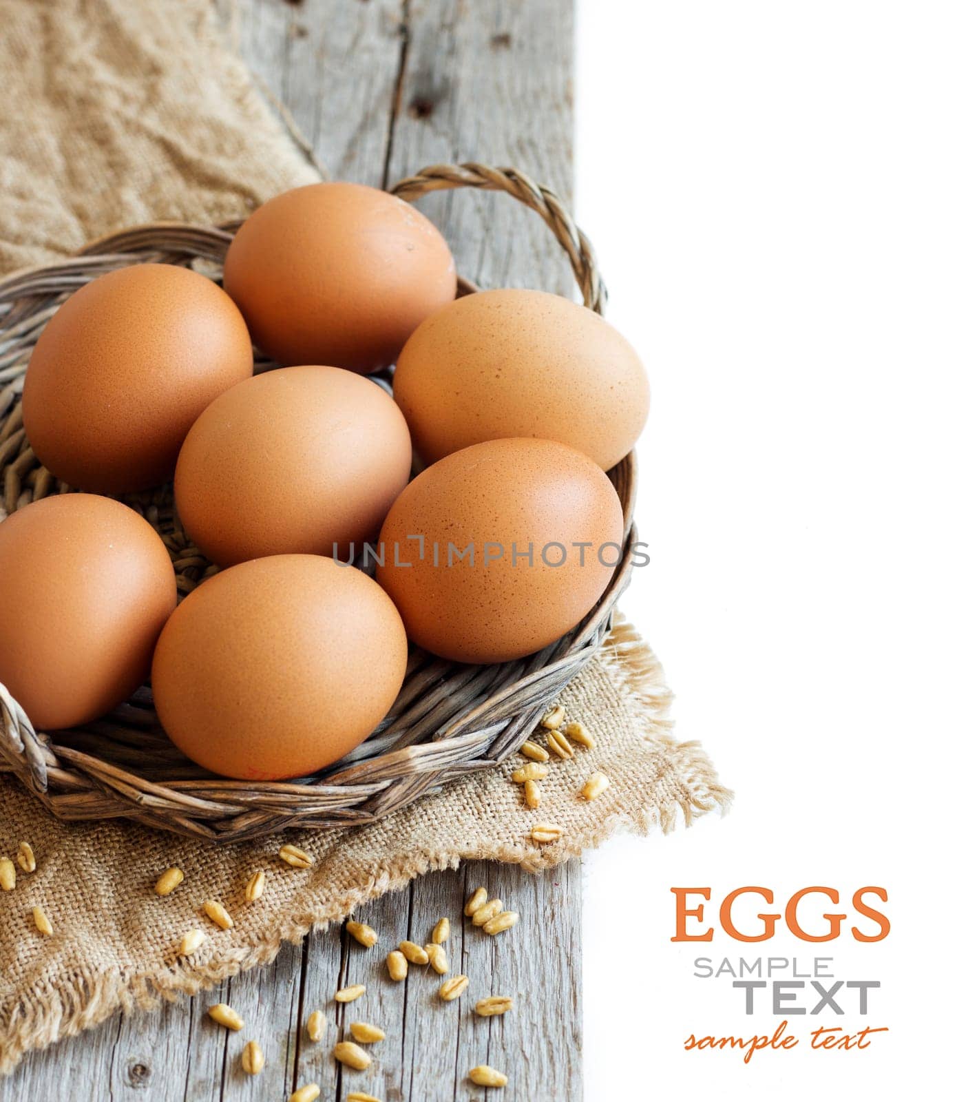 Chicken eggs and wheat on the old wooden table