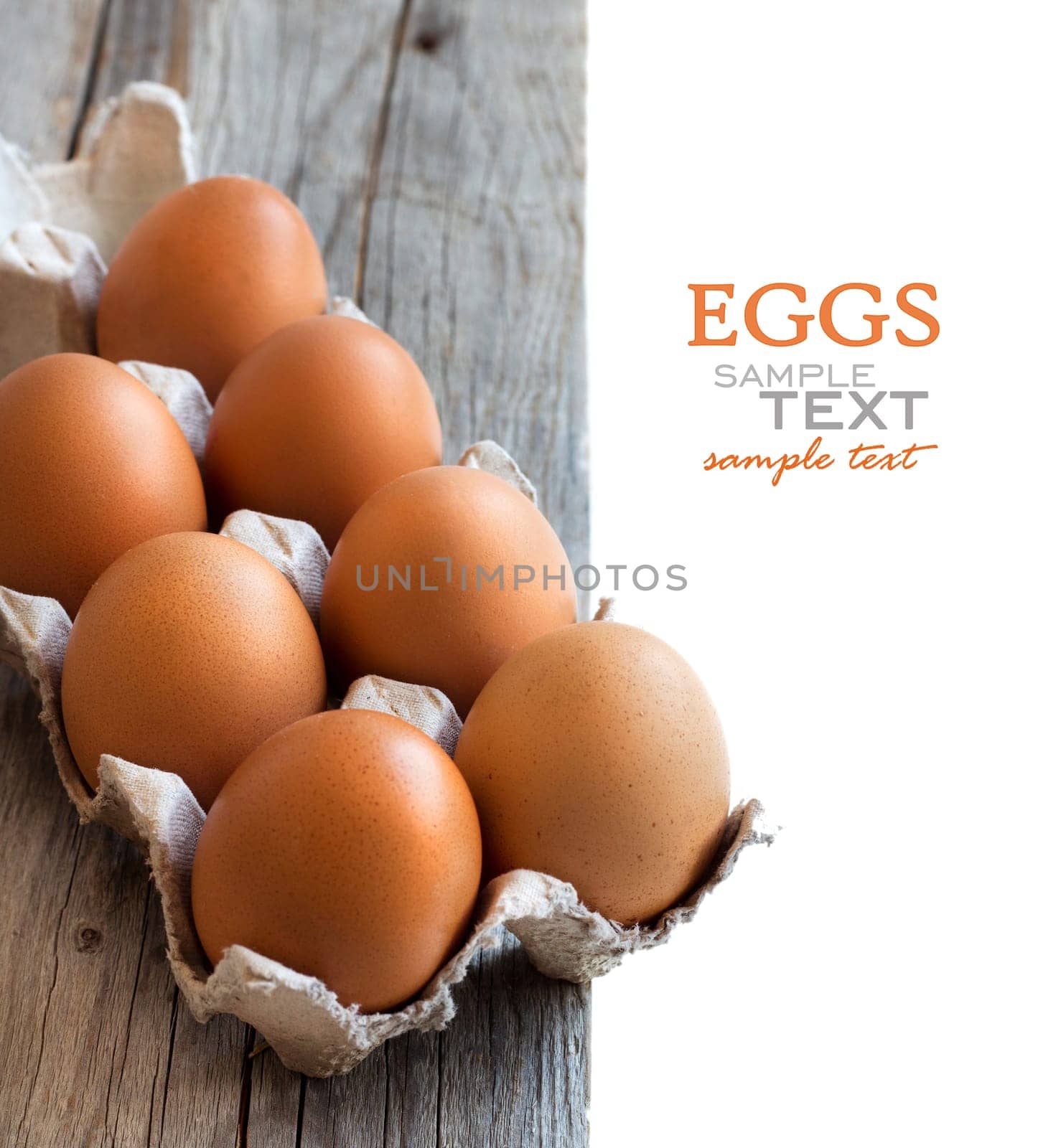 Chicken eggs in the package on the old wooden table