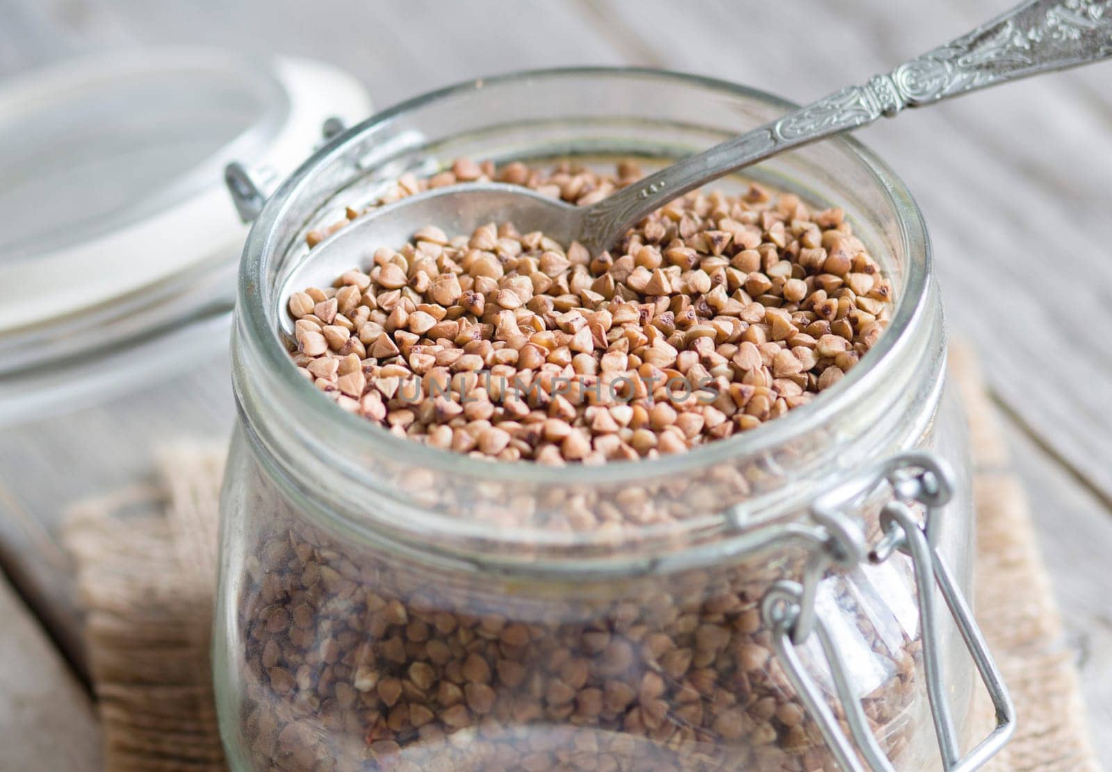 Buckwheat in a glass jar with a spoon