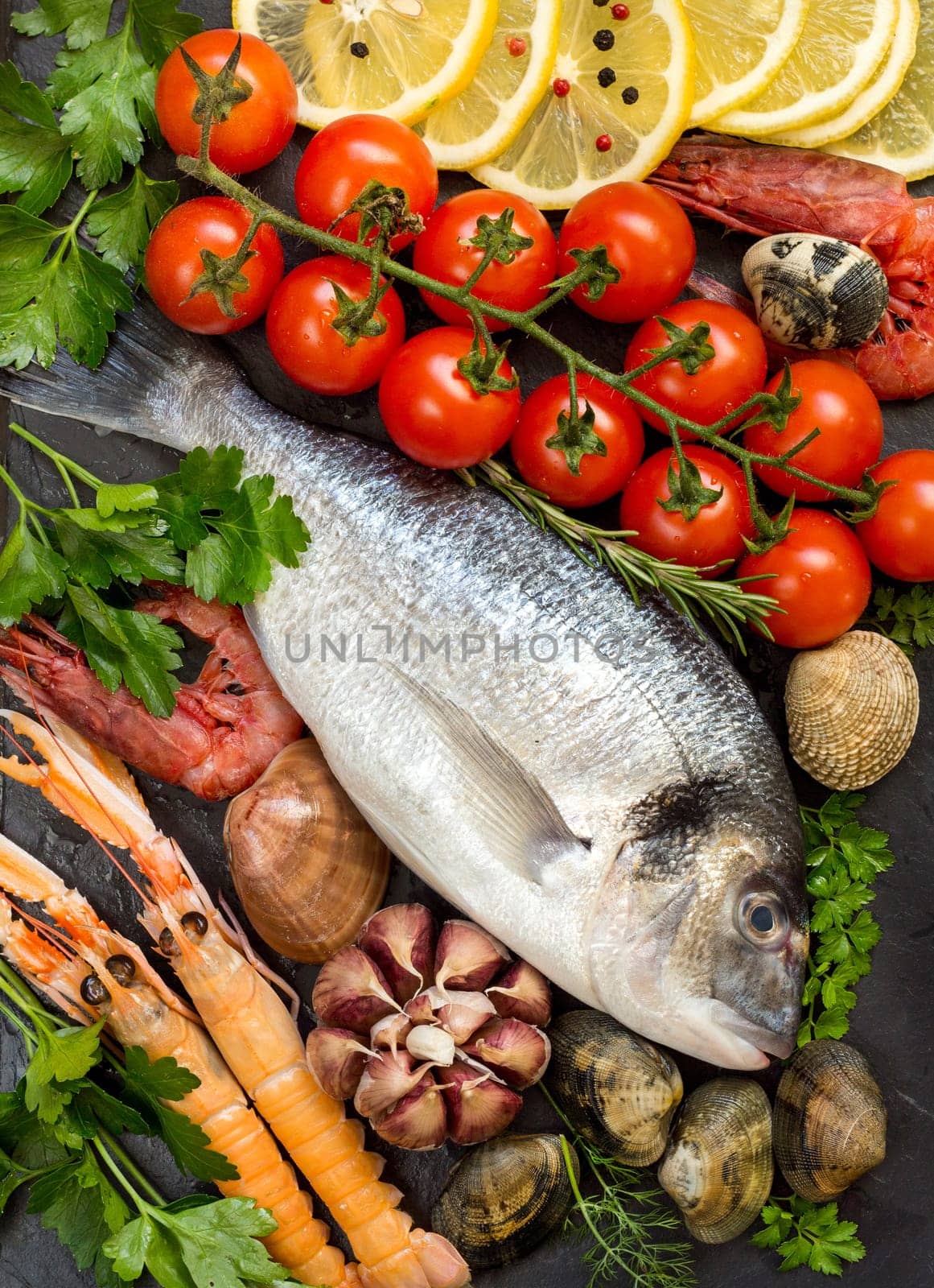Fresh dorado fish, seafood and vegetables