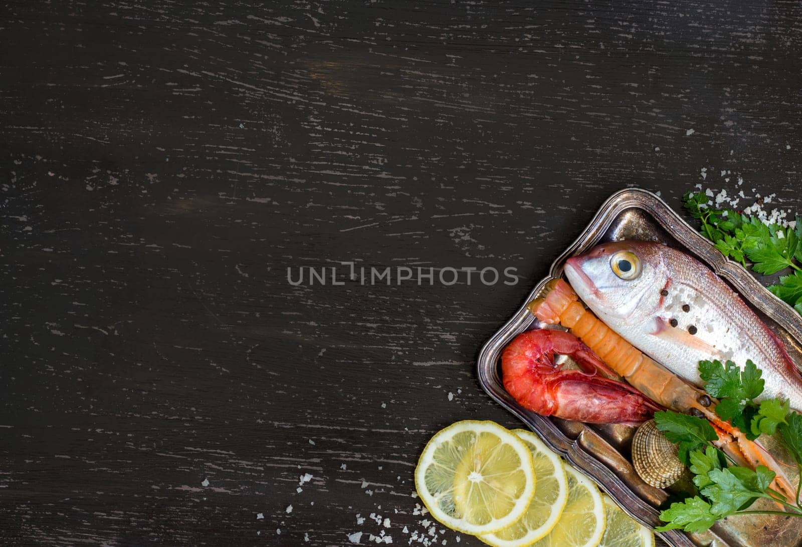 Fresh fish and seafood on a dark vintage background