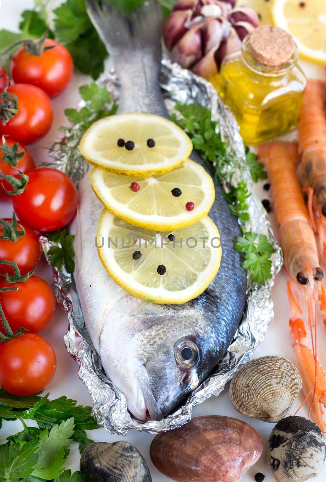 Fresh dorado fish, vegetables, olive oil and seafood