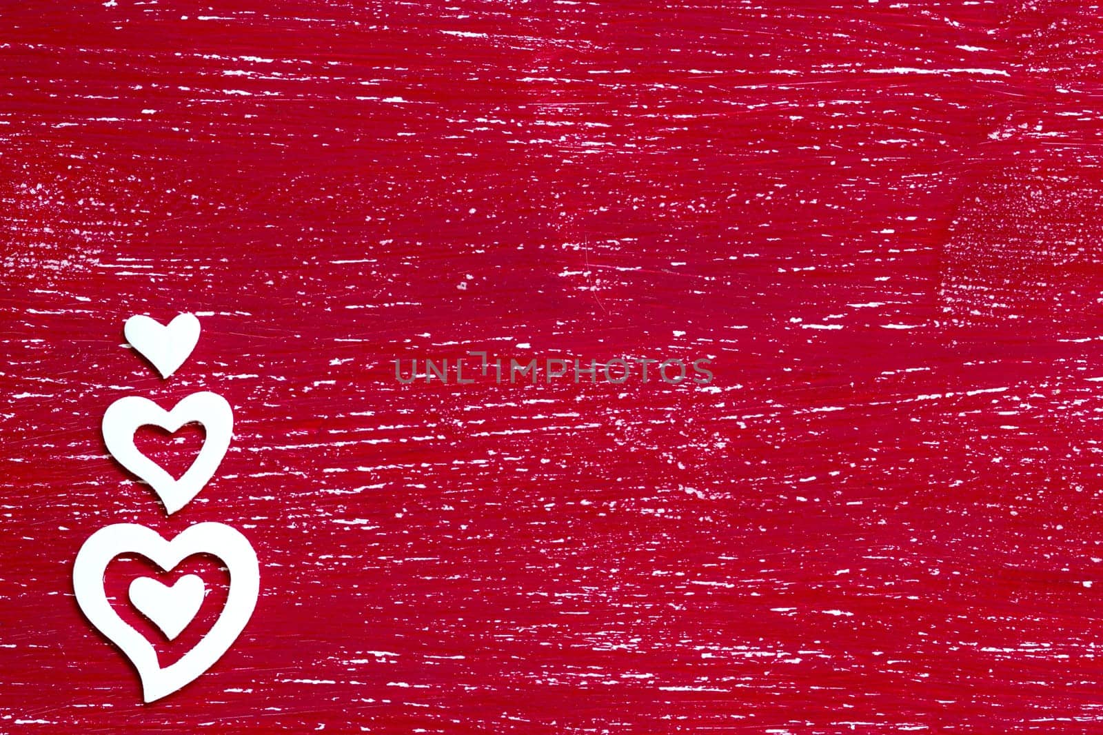 White hearts on a red shabby background