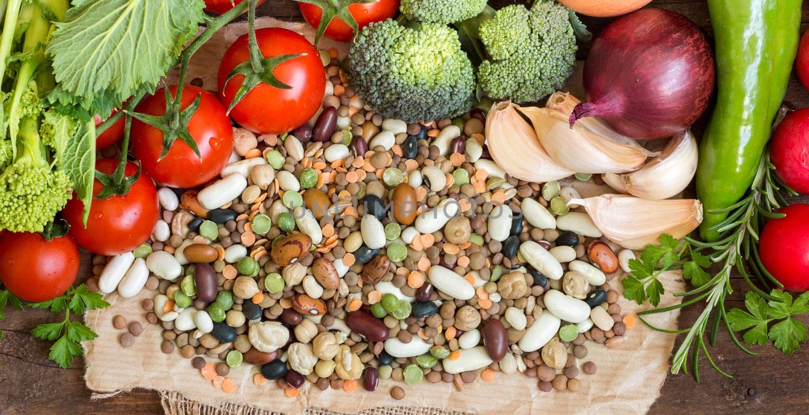 Mixed legumes and vegetables on the old wooden table