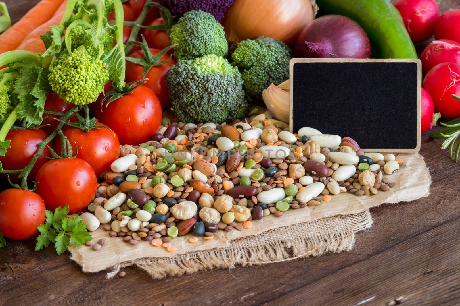 Mixed legumes and vegetables with a small chalkboard