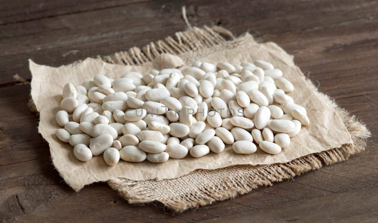 Pile of White beans on a wooden bacground