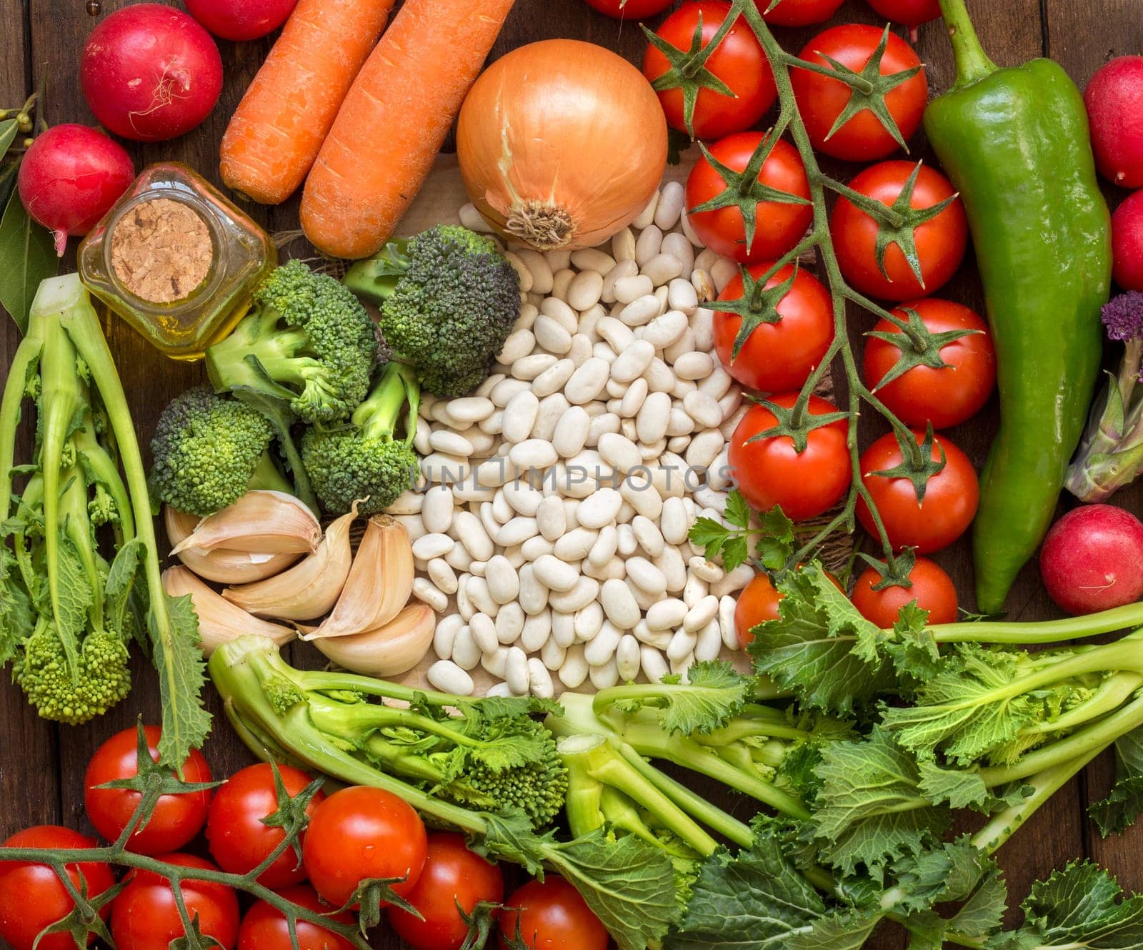 Plie of White beans with vegetables on wood