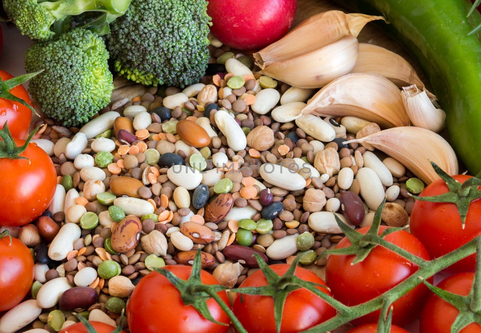 Mixed legumes and vegetables on a wooden table