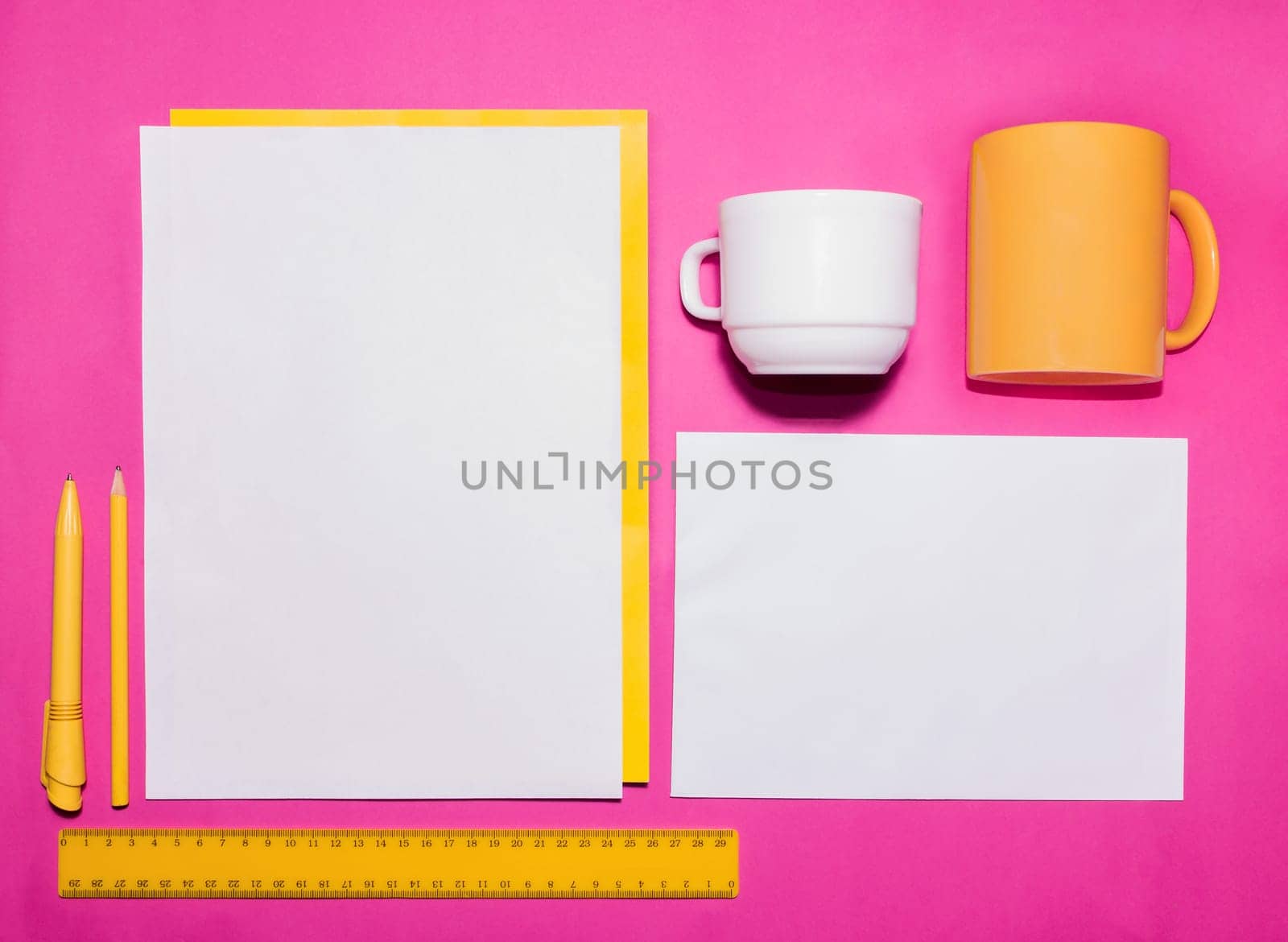 Mock-up business template with cards, papers, pen on pink background.