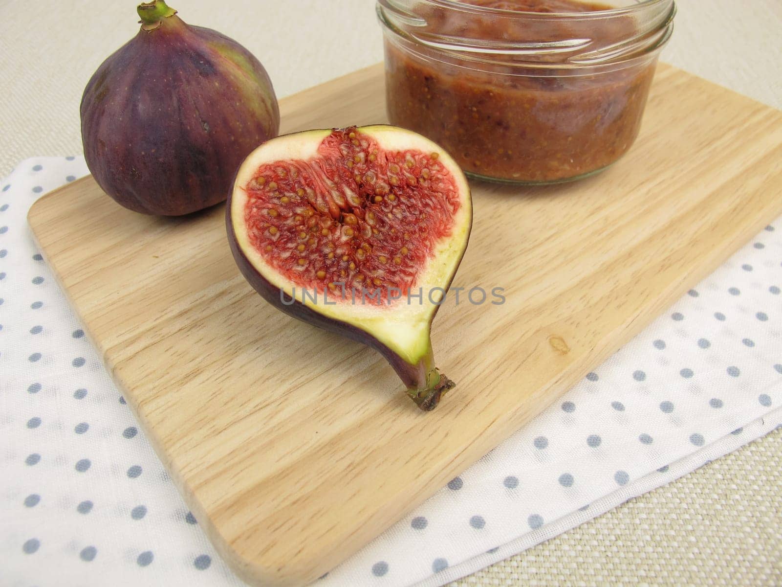 Homemade fig jam in a glass and fresh figs