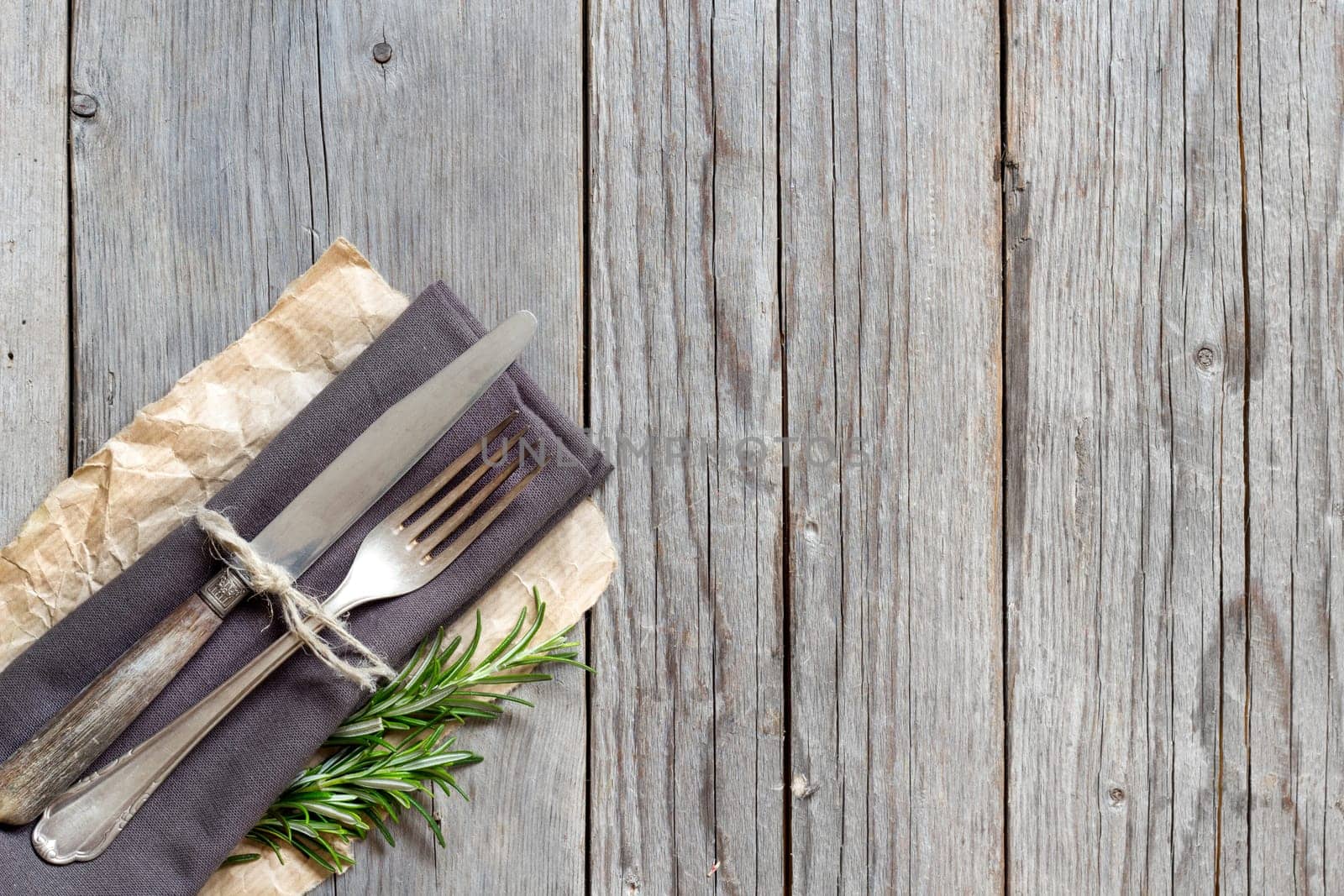 Vintage Table setting with rosemary decor on old wooden table