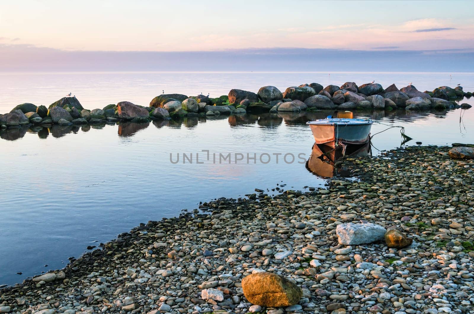 Beautiful Sunset and fishing boat on the coast