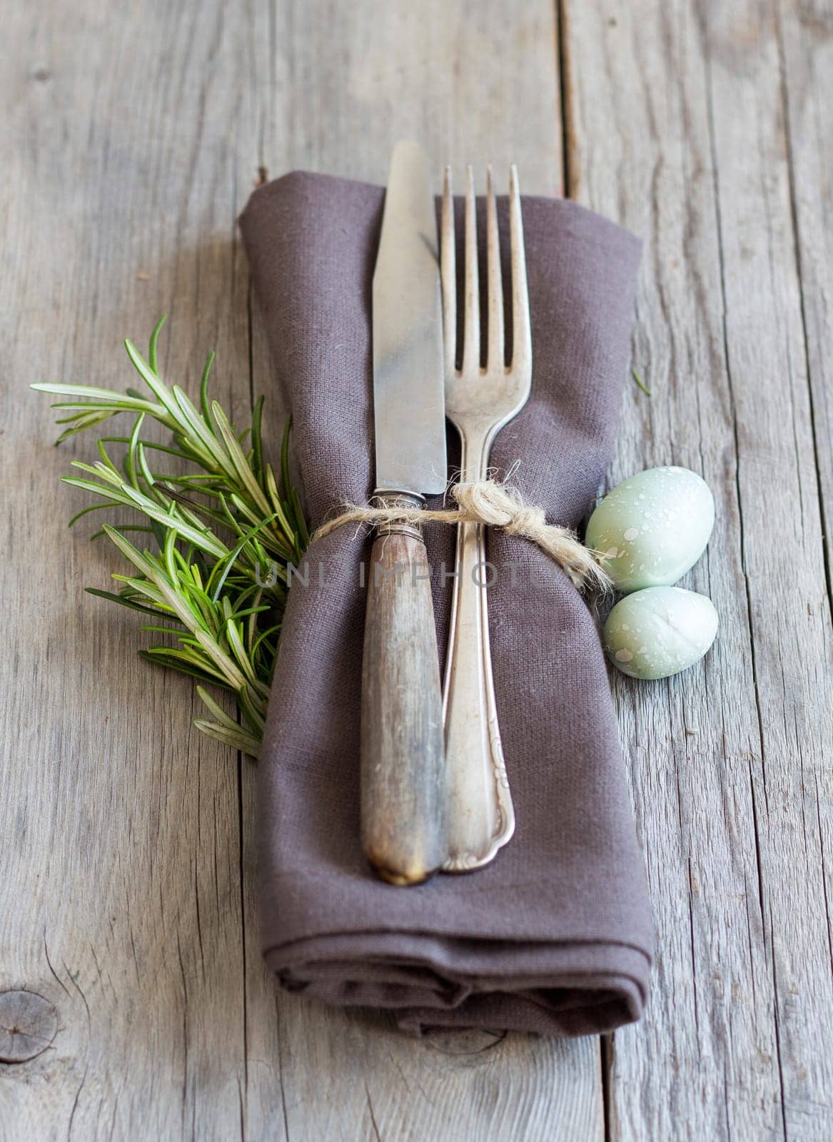Easter table setting with eggs and rosemary