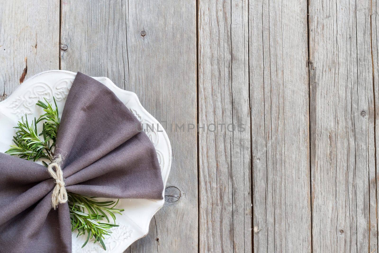 Vintage Table setting with rosemary decor on wood
