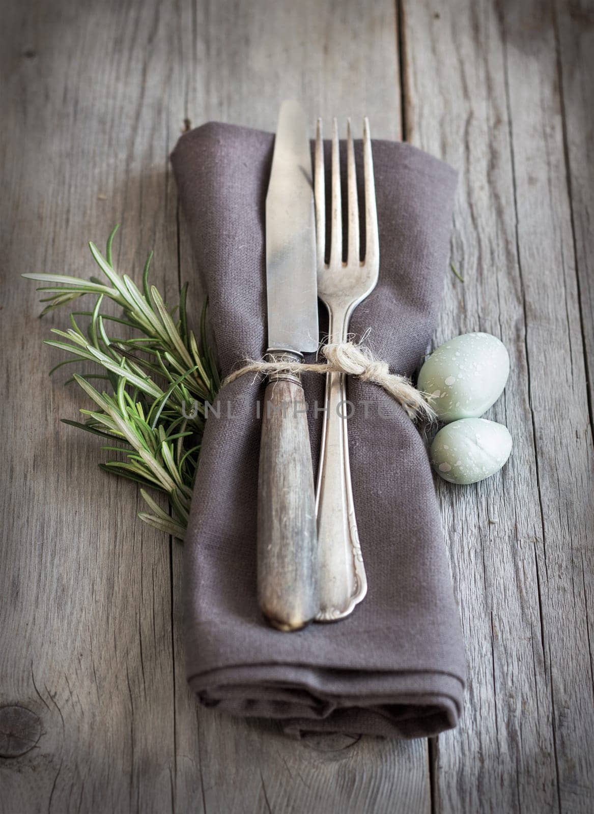 Easter table setting with eggs and rosemary