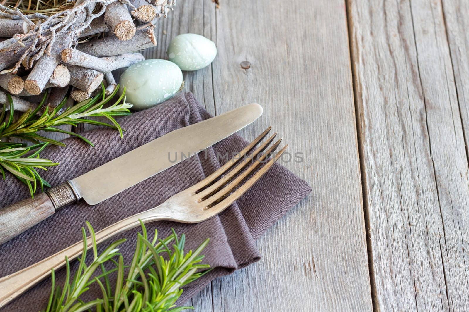 Easter table setting with eggs and rosemary