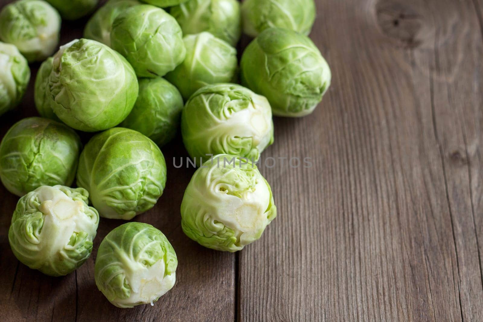 Brussels sprouts in a bowl on an old wooden table