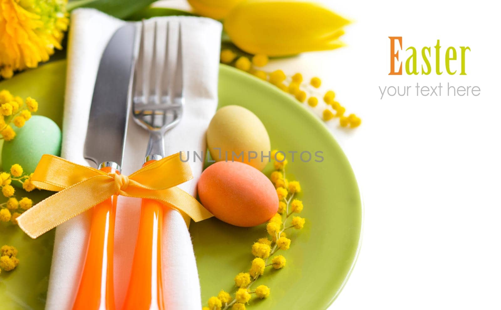 Easter table setting with yellow tulips and mimosa