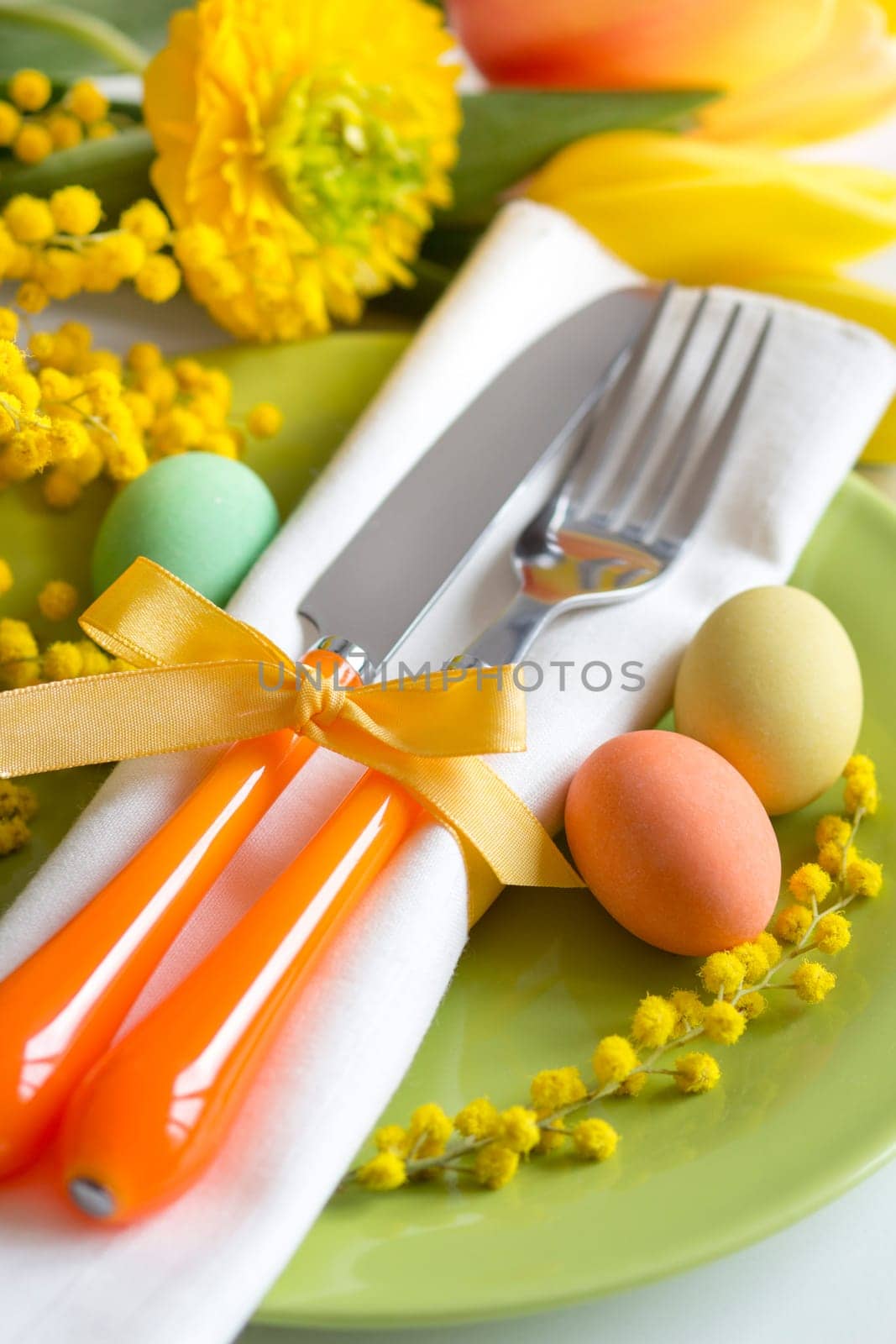 Easter table setting with yellow flowers and eggs