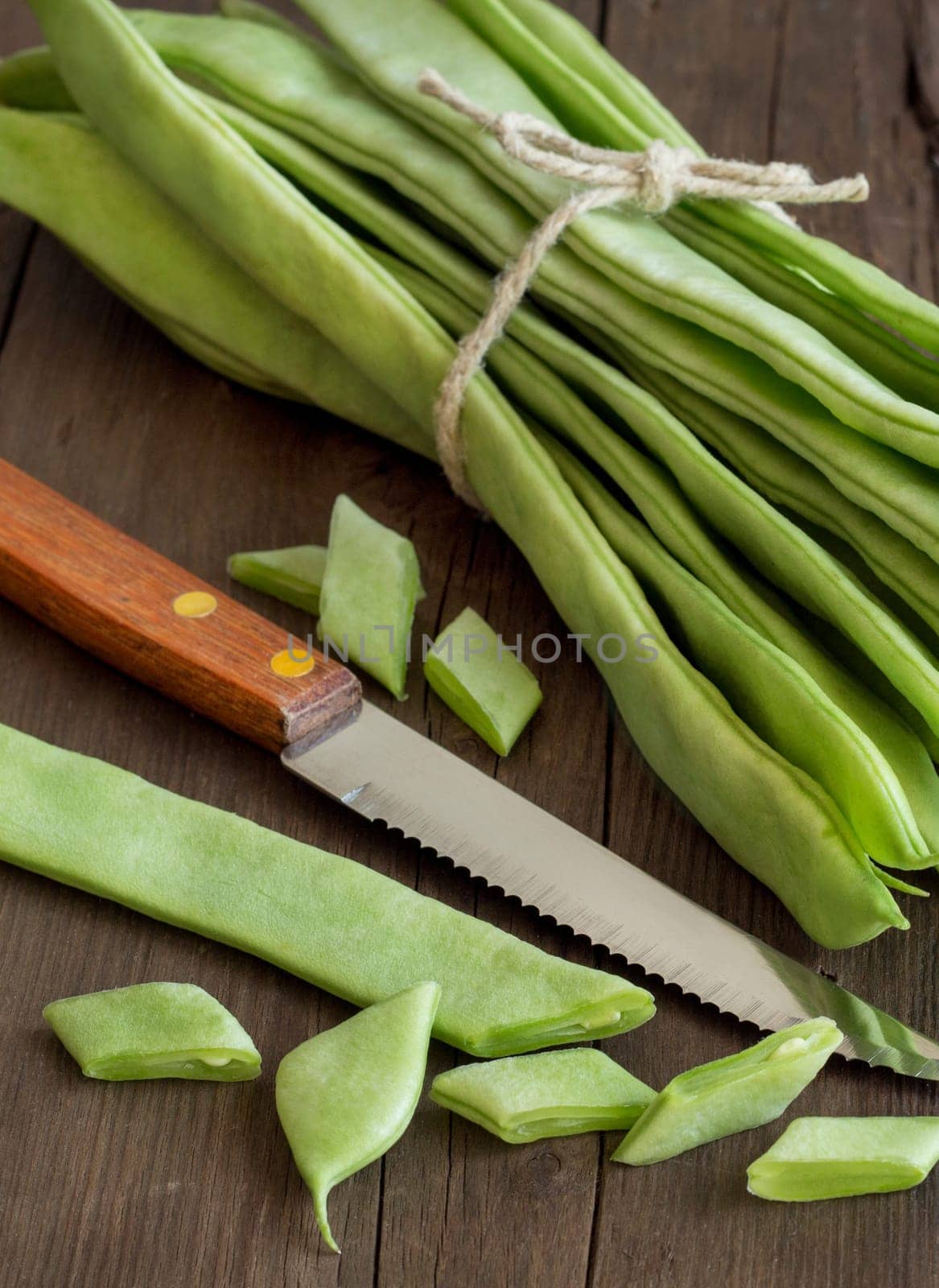 Piattoni green beans with knife on the old wooden table