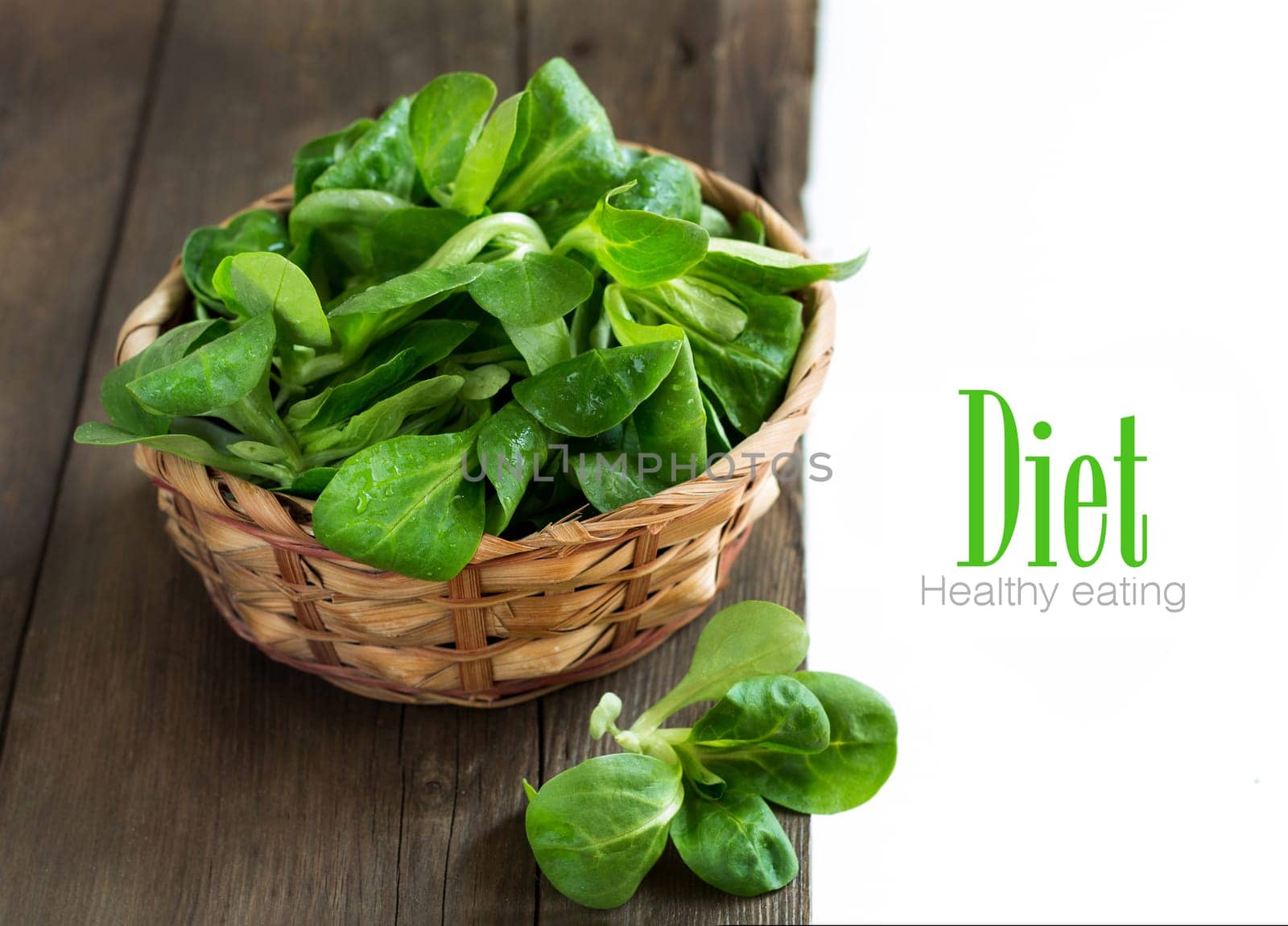 Field salad in a bowl on the old wooden table