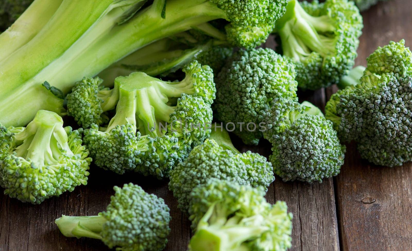 Fresh broccoli on old wooden table close up