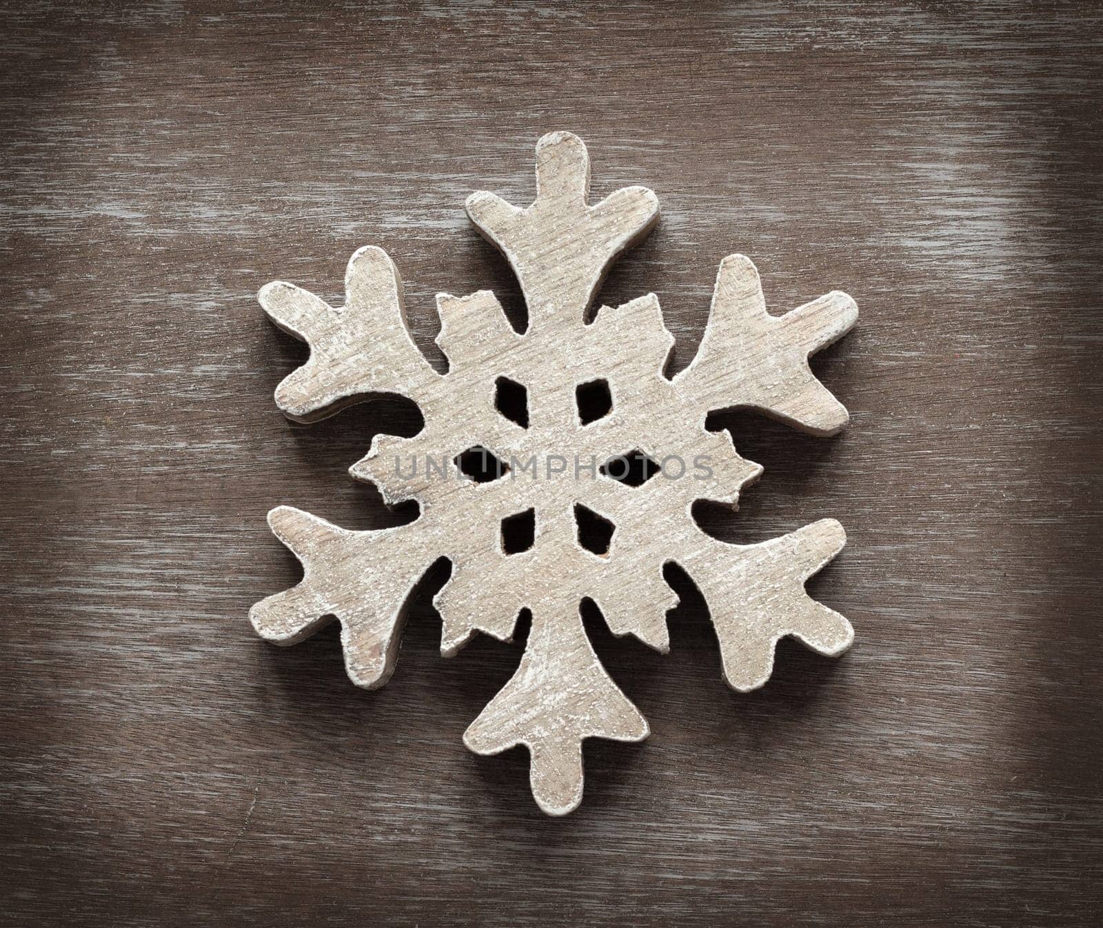 Wooden snowflake on a shabby chic wooden table