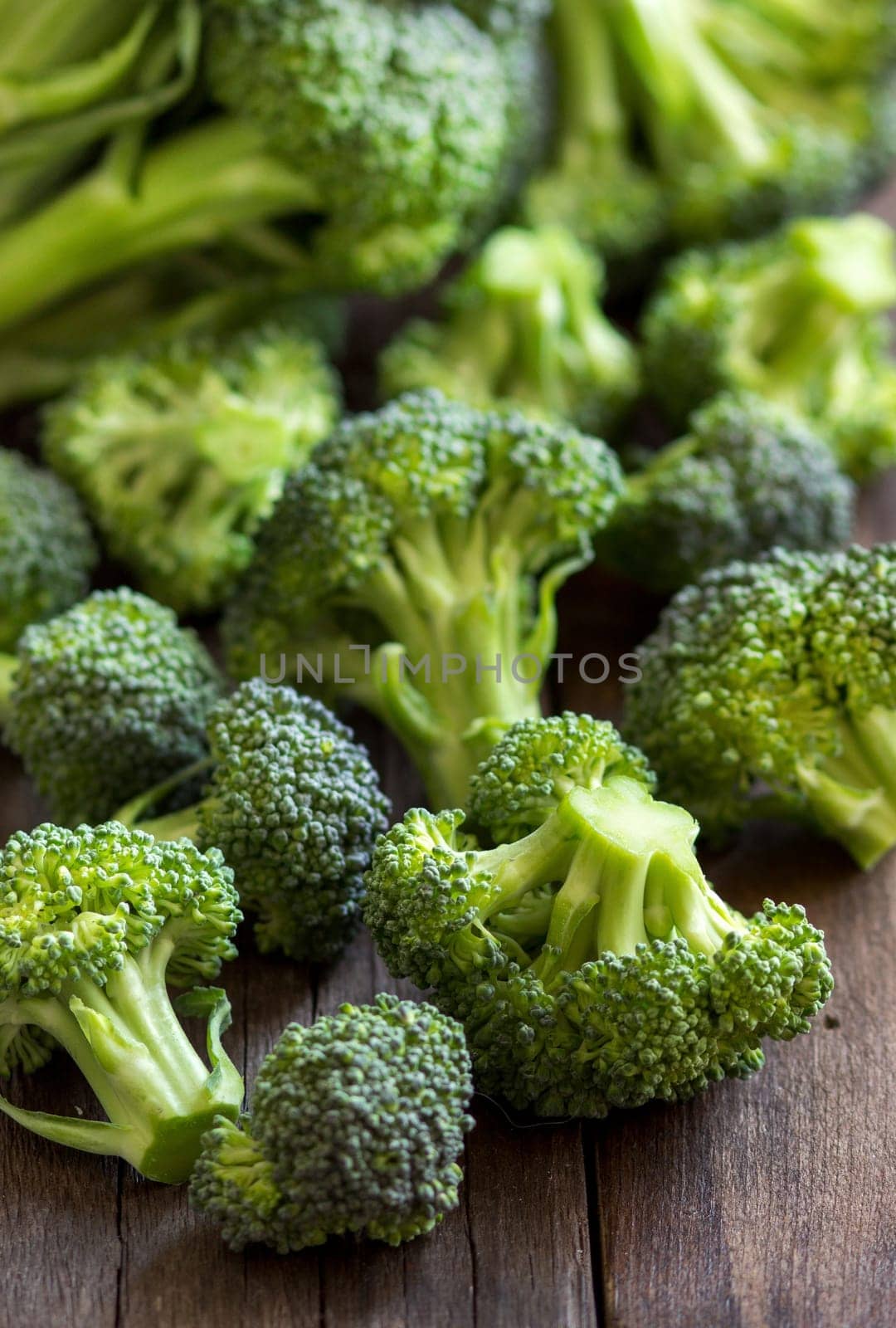 Fresh broccoli on old wooden table close up