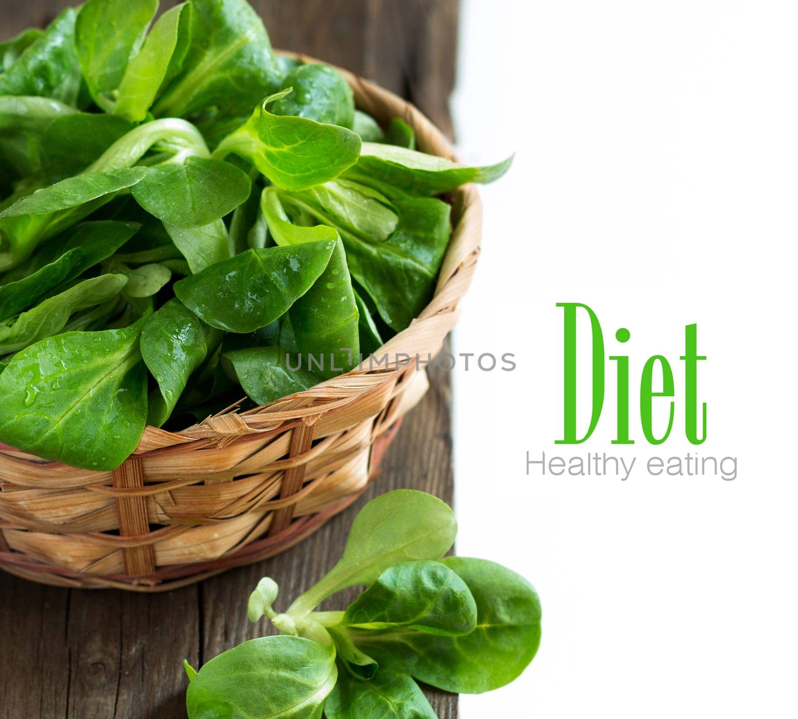 Field salad in a bowl on the old wooden table