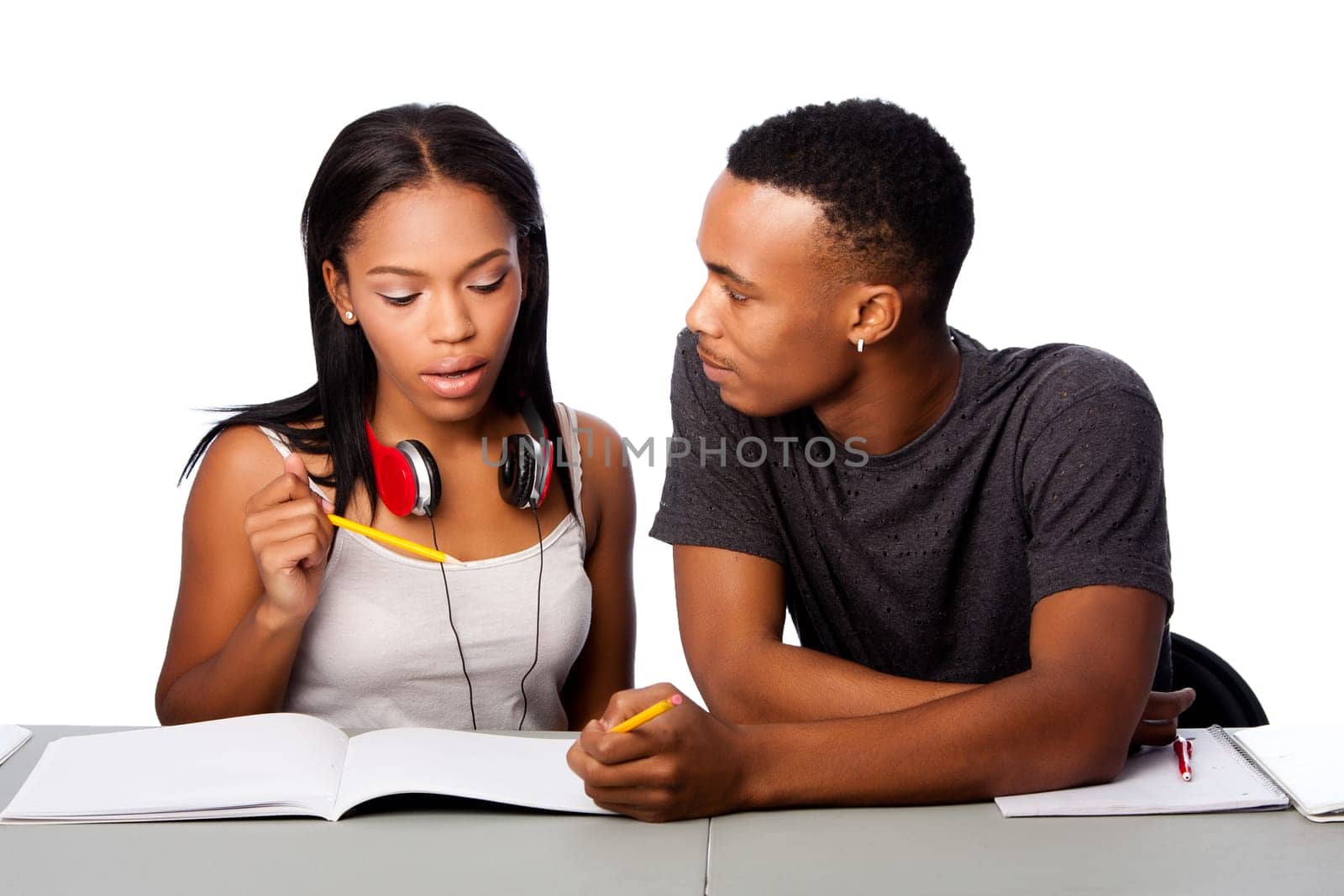 Two students happily studying together, on white.