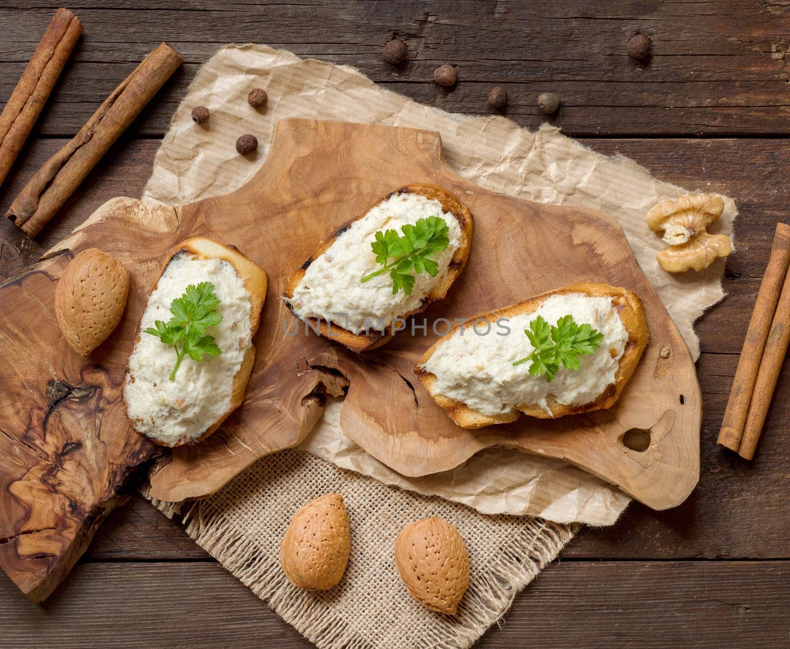 Toasted bread with a salted codfish mousse on wooden cutting board